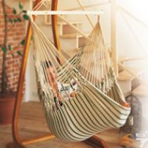 The large hanging chair made of soft cotton is relaxing.